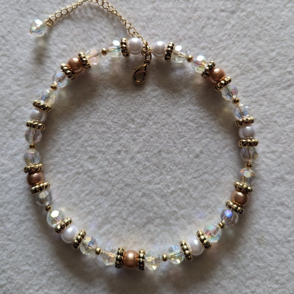 Choker with clear and pearl beads and gold accents.